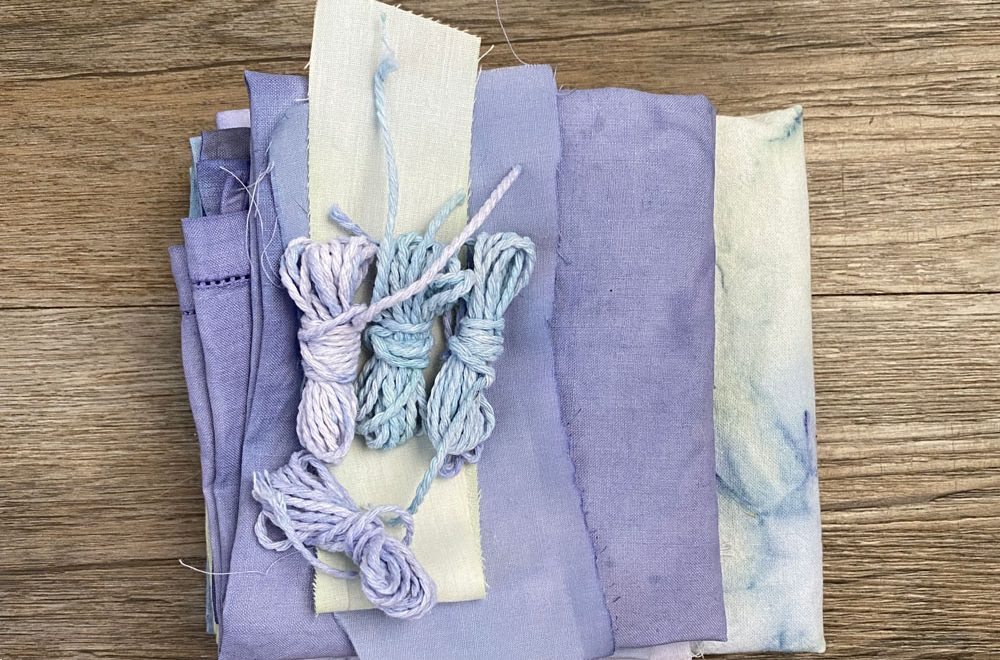 Stacked fabrics and strings with purple and blue tones